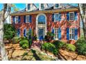 Lovely brick home featuring an arched window and blue shutters on a landscaped hill at 4506 Westcliff Ne Trce, Roswell, GA 30075