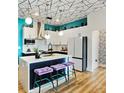 Chic kitchen features white cabinets, a central island with seating, and modern appliances at 112 Rogers Street Ne # 505, Atlanta, GA 30317