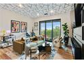 Bright living room with modern decor, a patterned ceiling, and sliding glass doors to the outside at 112 Rogers Street Ne # 505, Atlanta, GA 30317