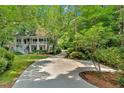 A long driveway leads to a stately home surrounded by mature trees and landscaping at 400 Old Ivy Ne Rd, Atlanta, GA 30342