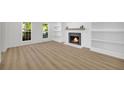 Bright living room with wood flooring, a fireplace, and built-in shelving at 1 N Boundary Nw Pl, Atlanta, GA 30318