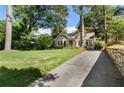 Beautiful home with a well-manicured lawn and a long driveway, exuding curb appeal and inviting charm at 414 E Wesley Ne Rd, Atlanta, GA 30305