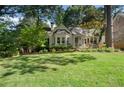 Charming cottage-style home with lush landscaping, inviting curb appeal, and a well-maintained front yard at 414 E Wesley Ne Rd, Atlanta, GA 30305
