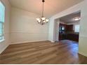 Classic dining room featuring modern wood-look floors and an elegant chandelier at 234 Silver Arrow Cir, Austell, GA 30168