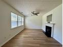 Bright living room boasting wood-look floors, a fireplace, and ample natural light at 234 Silver Arrow Cir, Austell, GA 30168
