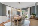 Cozy dining room with hardwood floors, modern lighting, and views into the entryway and butler's pantry at 2772 Hillgrove Dr, Dacula, GA 30019