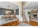 Elegant dining room featuring hardwood floors, a modern chandelier, and an open floor plan at 2772 Hillgrove Dr, Dacula, GA 30019