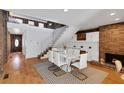 Open-concept dining area with fireplace, a modern staircase, and bright hardwood flooring at 549 Ne Parkway Ne Dr, Atlanta, GA 30308