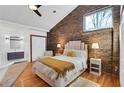 Stylish bedroom with brick accent wall, modern décor, and ensuite bathroom at 549 Ne Parkway Ne Dr, Atlanta, GA 30308