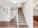 Spacious entryway featuring hardwood floors and carpeted stairs leading to the upper level at 1752 Shadybrook Ct, Lawrenceville, GA 30043