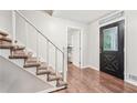 Inviting entryway with hardwood floors, staircase, and decorative front door at 1752 Shadybrook Ct, Lawrenceville, GA 30043