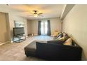 Cozy living room with tile floors, couch, and patio doors at 125 Rue Fontaine, Lithonia, GA 30038