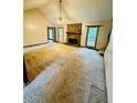 Bright living room featuring a stone fireplace, vaulted ceilings, and carpet at 1905 Sidneys Cv, Lawrenceville, GA 30043