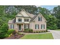 Charming two-story brick home with well-maintained lawn and lovely landscaping features at 223 Falling Water Way, Woodstock, GA 30188
