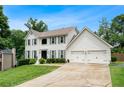 Beautiful white two-story home with attached garage and well manicured lawn at 3710 Robinson Walk Ct, Marietta, GA 30068