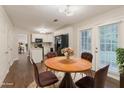 Bright dining area with wood table, chairs, and kitchen access at 5352 Windfern Ct, Stone Mountain, GA 30088