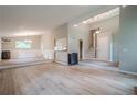 Open concept living space with sleek hardwood floors, modern lighting, and wainscoting detail at 1137 Poplar Log Pl, Austell, GA 30168