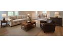 Cozy living room with modern decor, neutral furniture, and hardwood flooring at 1137 Poplar Log Pl, Austell, GA 30168