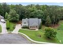 Lovely aerial view of a home with mature trees, stone accents, and well-manicured lawn at 12 Isabella Ne Ct, Cartersville, GA 30121