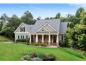 Charming home with stone accents, a well-manicured lawn, and lush landscaping provides great curb appeal at 12 Isabella Ne Ct, Cartersville, GA 30121