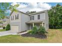 Beautiful two-story home boasts an attached garage, a well-kept lawn, and delightful landscaping at 236 Arbor Creek Dr, Dallas, GA 30157
