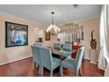 Elegant dining room with a modern chandelier, a glass table, and seating for six at 3573 Willow Tree Trce, Decatur, GA 30034