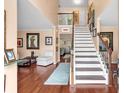 Bright and airy foyer with beautiful hardwood floors, a classic staircase, and elegant decor at 3573 Willow Tree Trce, Decatur, GA 30034