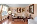 Cozy living room with natural light, hardwood floors, and a comfortable sofa at 3573 Willow Tree Trce, Decatur, GA 30034