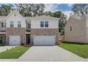 New townhome featuring brick and siding, complemented by a manicured lawn at 389 Navigator Ln, Mcdonough, GA 30253