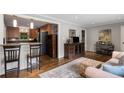 Open-concept living area featuring a breakfast bar and hardwood floors at 1060 Pinedale Se Dr, Smyrna, GA 30080