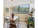 Charming dining room with modern chairs and oversized windows for natural light at 3530 Piedmont Ne Rd # 2I, Atlanta, GA 30305