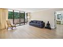 Spacious living room featuring a wall of windows and light, wood-look floors at 3530 Piedmont Ne Rd # 2I, Atlanta, GA 30305