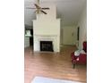 Spacious living room with a cozy fireplace, and views into the kitchen area at 425 Rockingham Ln, Woodstock, GA 30189