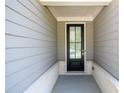 Stylish home entrance featuring a black front door, white trim, and gray siding at 2856 Knob Creek Dr, Snellville, GA 30078