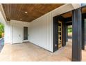 Open-air entryway featuring modern lighting and wood accents, leading to a stylish front door and adjacent white door at 178 Wesley Ne Ave # A, Atlanta, GA 30307