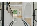 Bright foyer with marble floors, staircase with iron railings, and arched doorway at 2797 Benson Dr, Marietta, GA 30062