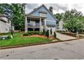 Charming two-story blue home with a welcoming front porch and manicured landscaping at 2956 Silver Hill Se Ter, Atlanta, GA 30316