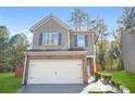 Charming two-story home featuring a brick facade and a two-car garage with an inviting front lawn at 3143 Bonnes Dr, Stonecrest, GA 30038