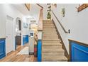 Carpeted staircase with wood banister leading to the upper level of the home at 3143 Bonnes Dr, Stonecrest, GA 30038
