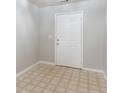 Simple entrance area features neutral walls and beige vinyl tile flooring at 541 Shadow Valley Ct, Lithonia, GA 30058