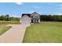 Inviting two-story home on a sprawling lawn with a long driveway at 715 Colvin Dr, Locust Grove, GA 30248