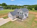 Aerial view of charming two-story home with two-car garage and manicured lawn at 715 Colvin Dr, Locust Grove, GA 30248