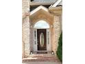 Close-up of the front door with an oval glass insert, sidelights, and brick detailing, enhancing curb appeal at 255 Carriage Station Dr, Lawrenceville, GA 30046