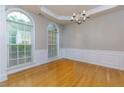 Dining room with hardwood floors, wainscoting, chandelier, and large windows at 118 Brendylynn Trce, Woodstock, GA 30188