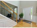 Bright foyer with hardwood floors, staircase with black iron spindles, and a view of the front door at 118 Brendylynn Trce, Woodstock, GA 30188