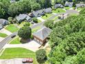 Aerial view of a home surrounded by mature trees in a suburban neighborhood at 208 Regency Ct, Acworth, GA 30102