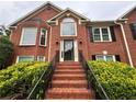 Classic brick home with stately entrance and black trimmed windows at 208 Regency Ct, Acworth, GA 30102