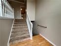 Inviting foyer with hardwood floors and carpeted staircase with white railing at 208 Regency Ct, Acworth, GA 30102