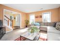 Bright and airy living room featuring neutral walls, carpeted flooring, and a comfortable sectional sofa at 3090 Perch Sw Ln, Marietta, GA 30008