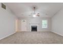 Neutral living room featuring a fireplace and abundant natural light at 5888 Old Wellborn Trce, Lithonia, GA 30058